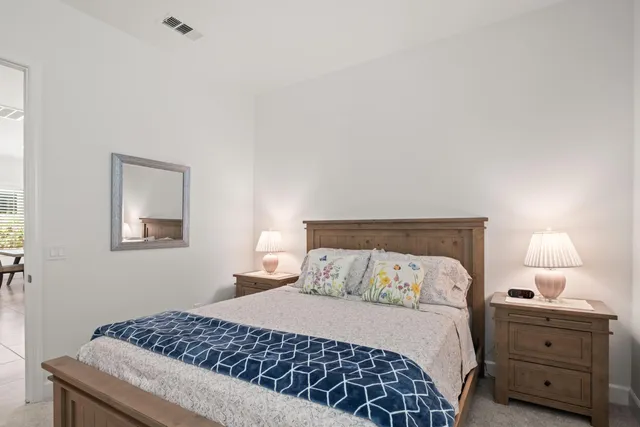 a bedroom with a bed and a lamp