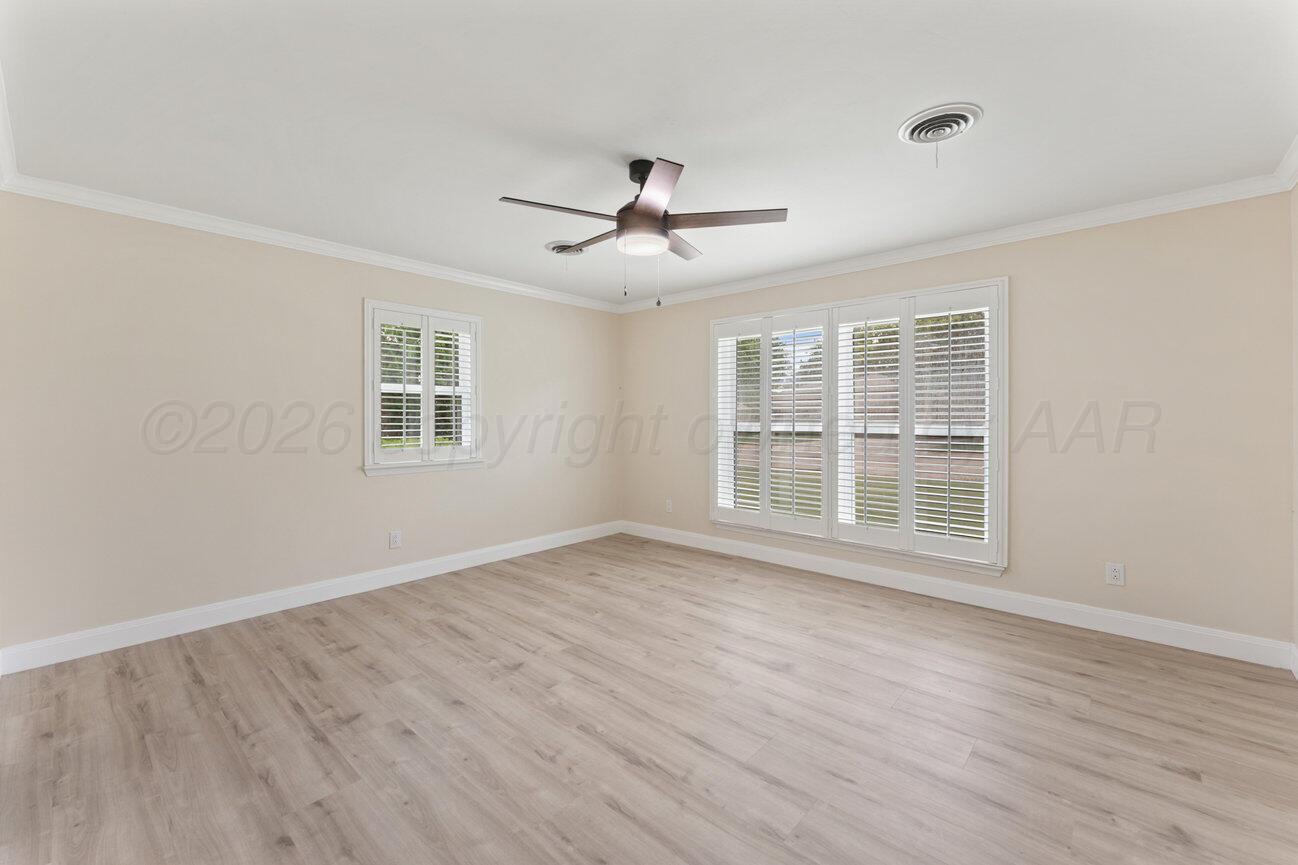 7204 Southwest 39th Avenue Amarillo, TX 79109 - Photo 24 of 51 a view of empty room with wooden floor and fan