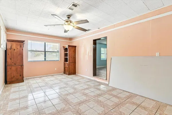 a view of a livingroom with a ceiling fan and window