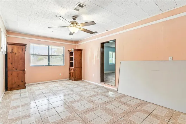 a view of a livingroom with a ceiling fan and window