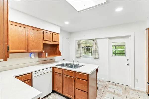 a kitchen with stainless steel appliances granite countertop a sink stove and cabinets