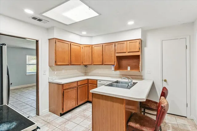 a kitchen that has a sink and a chair in it