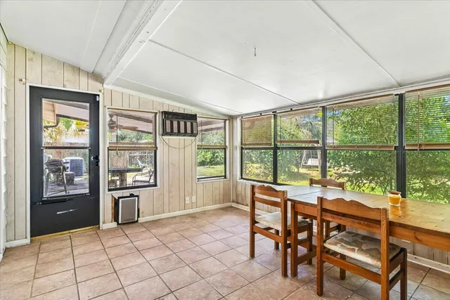 a living room with furniture and a floor to ceiling window