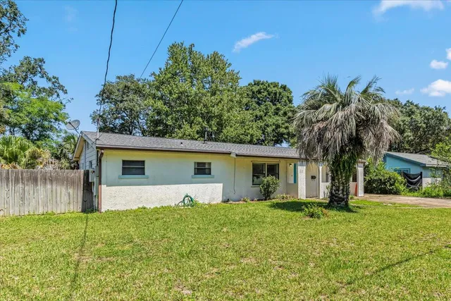 a front view of house with yard and green space