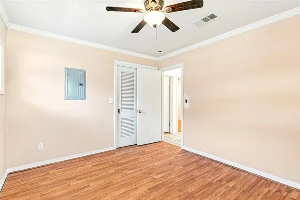 a view of empty room with wooden floor