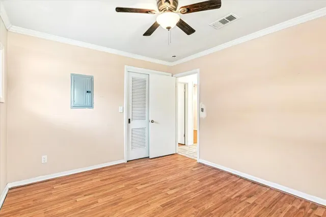 a view of empty room with wooden floor