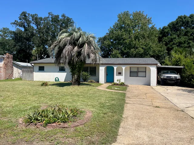 a front view of house with yard and trees