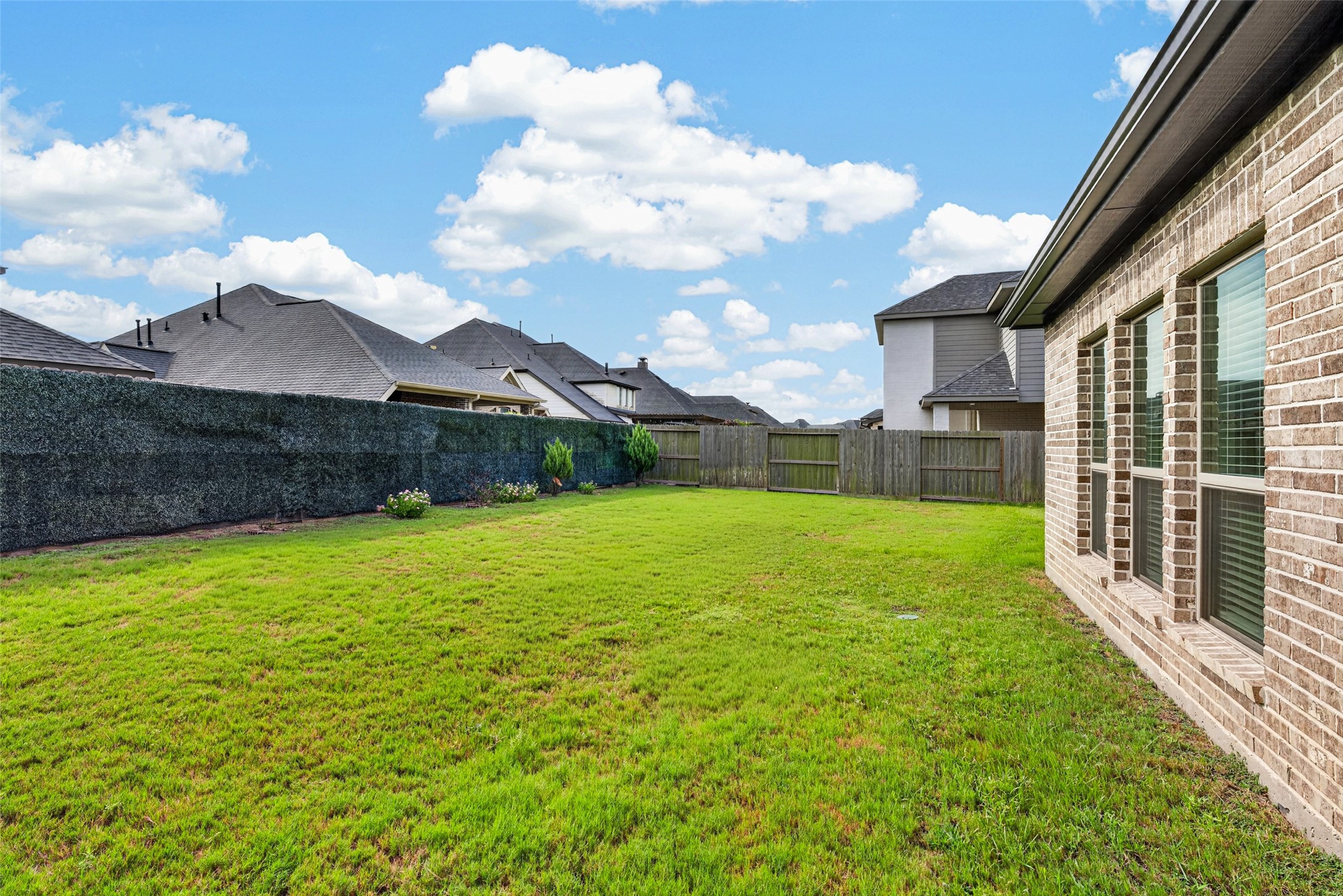 4207 Ana Ridge Lane Fulshear, TX 77441 - Photo 34 of 37 Sprawling, fully fenced backyard with an abundance of green space—offering endless potential for your dream in-ground pool, a lush garden setup, or a fun outdoor playground for the whole family!