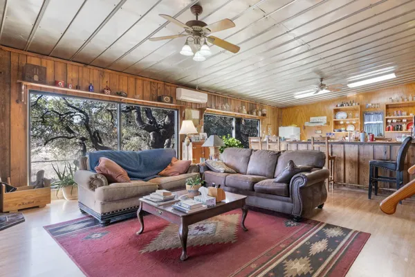a living room with furniture a ceiling fan and a rug