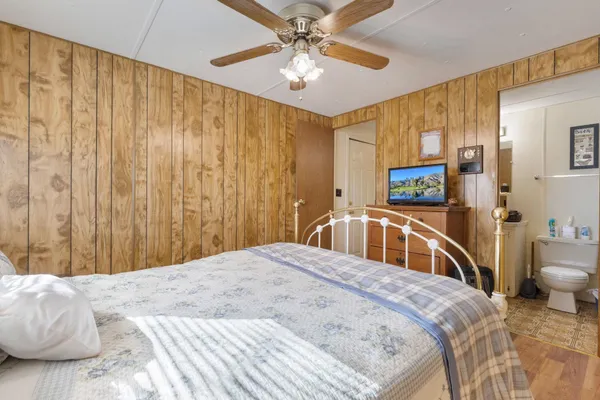 a bedroom with a bed and a chandelier