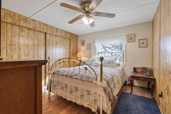 a bed sitting in a bedroom next to a window