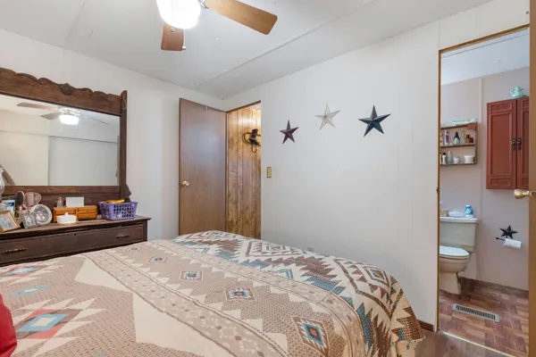 a bedroom with a bed and a mirror
