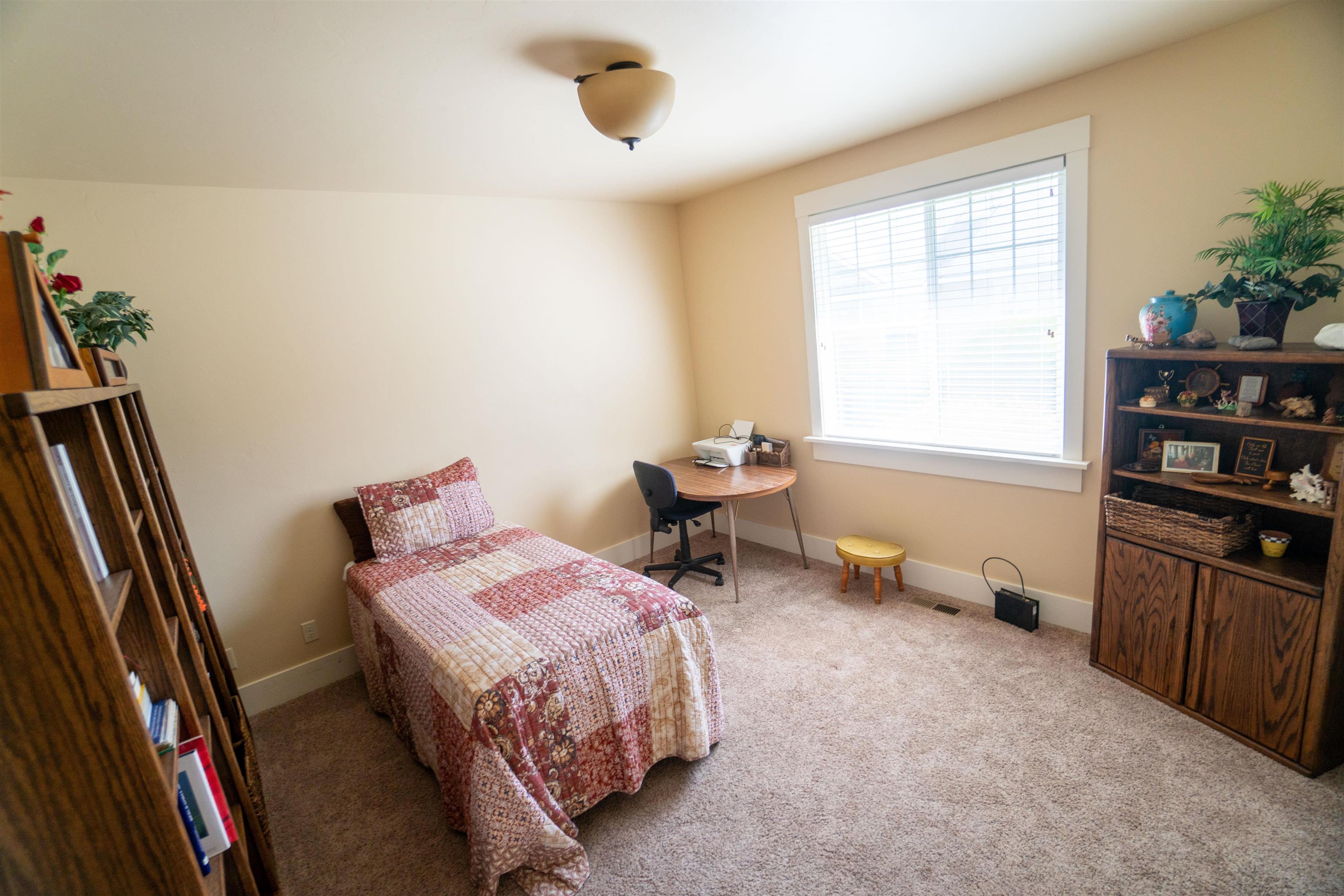 1111 Daisy Lane, Unit 32 Fruita, CO 81521 - Photo 17 of 23 a bedroom with bed and a large window