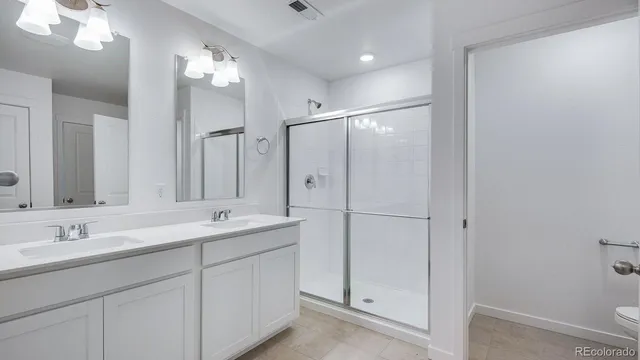 a spacious bathroom with a double vanity sink mirror and double