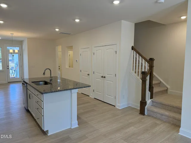 a kitchen with granite countertop a sink and a stove top oven