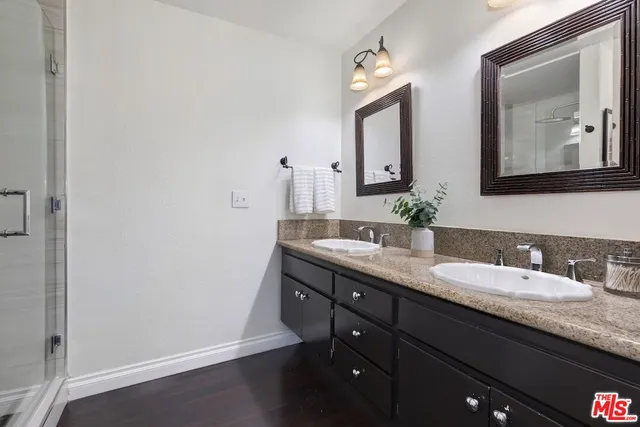 a bathroom with a double vanity sink and a mirror