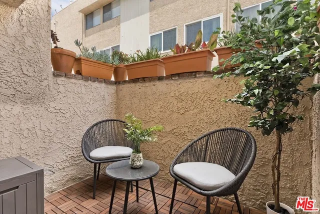 a backyard of a house with table and chairs