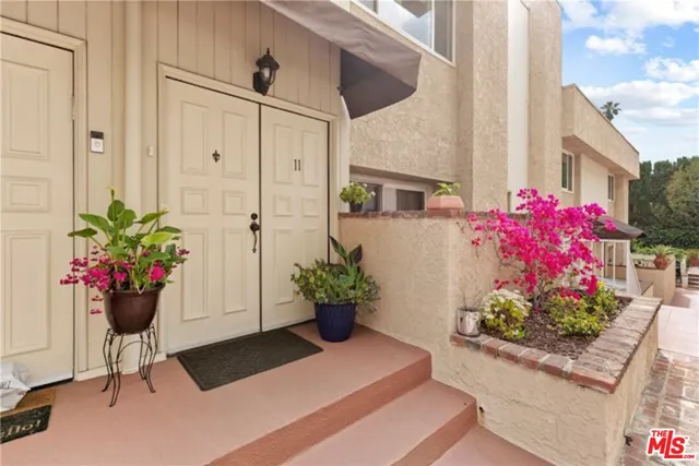 a view of a entryway with flower pots