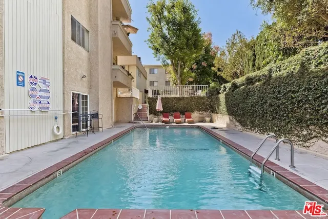 a view of swimming pool with a yard