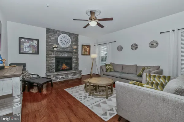 a spacious bedroom with a bed a couch and a chandelier