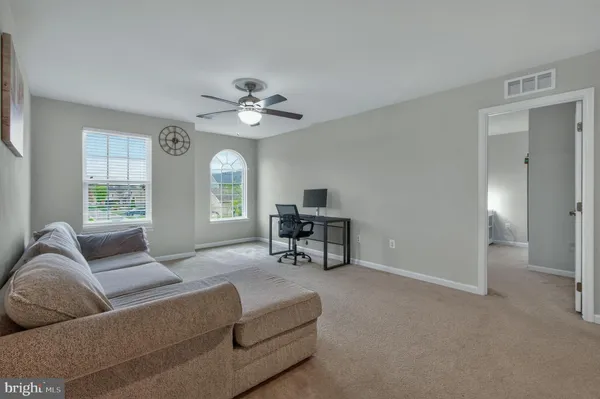 a bedroom with a bed a desk and chair