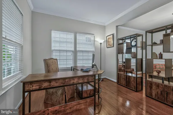 a view of a workspace with furniture and window