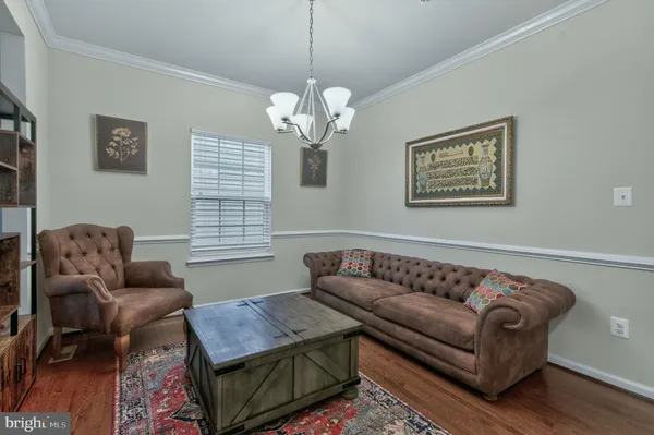 a kitchen with stainless steel appliances a dining table chairs stove and refrigerator