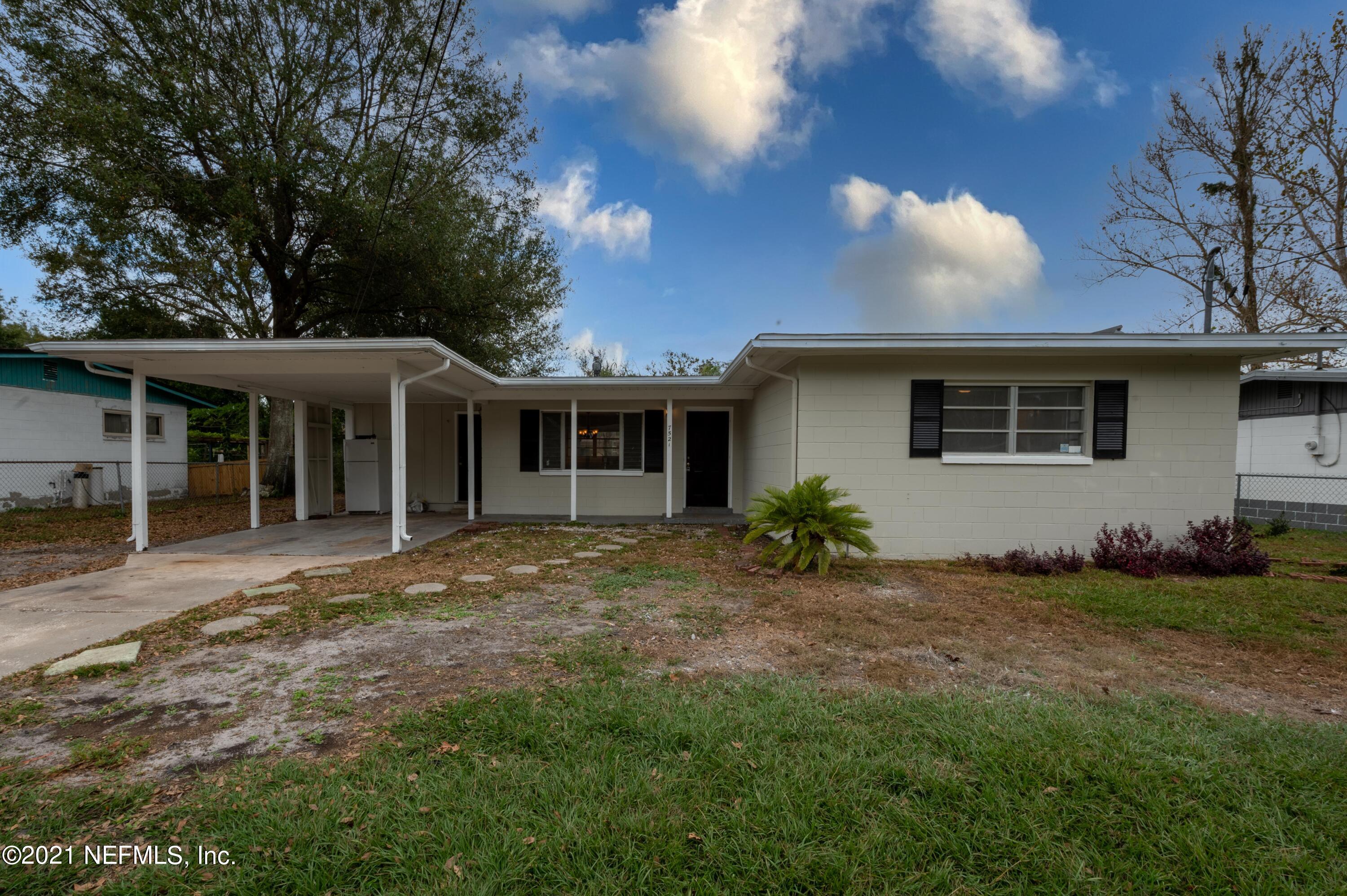 7521 Strato Road Jacksonville, FL 32210 - Photo 1 of 40 a front view of a house with a garden