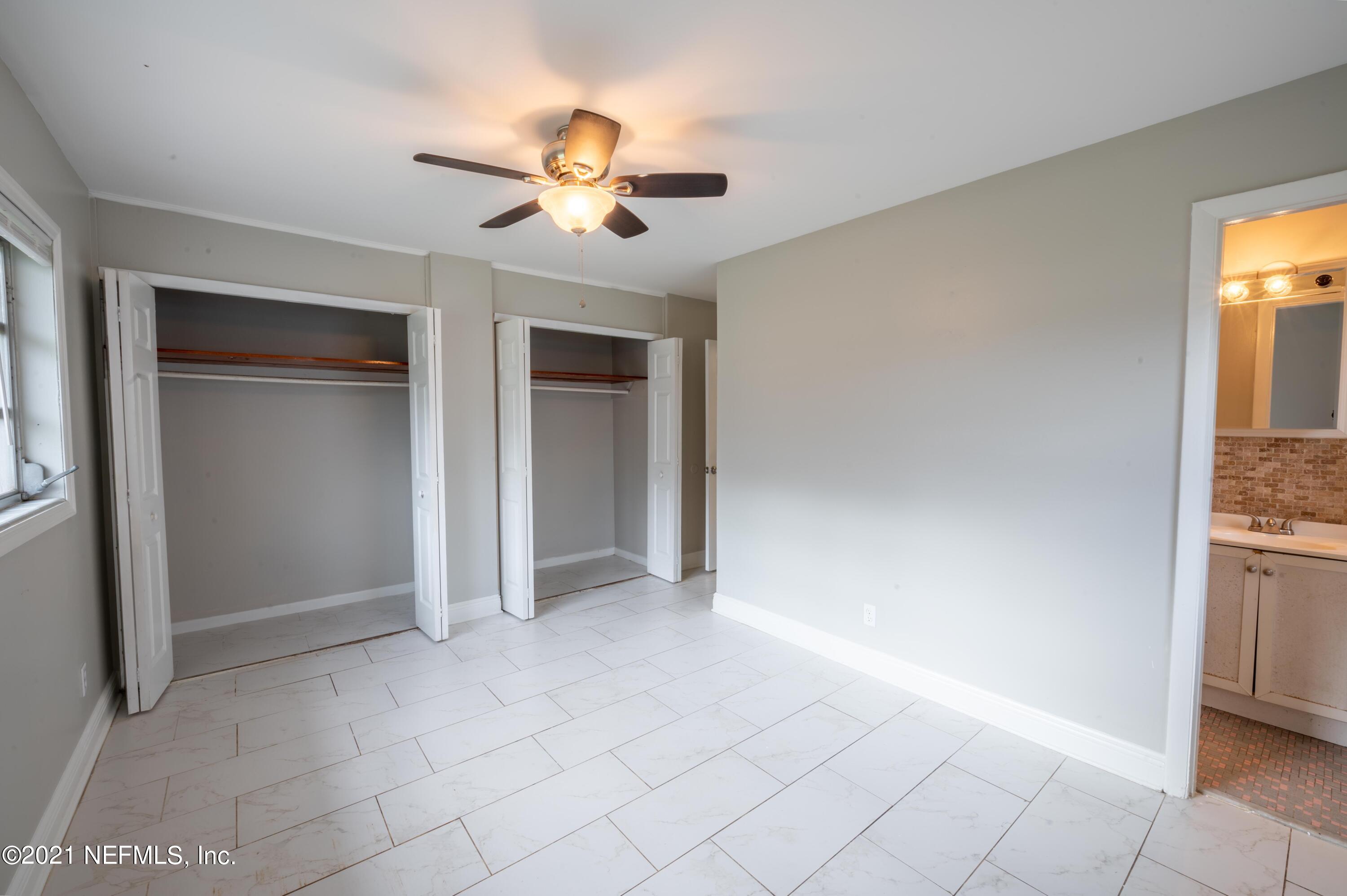 7521 Strato Road Jacksonville, FL 32210 - Photo 11 of 40 a view of an empty room with chandelier fan and fire place