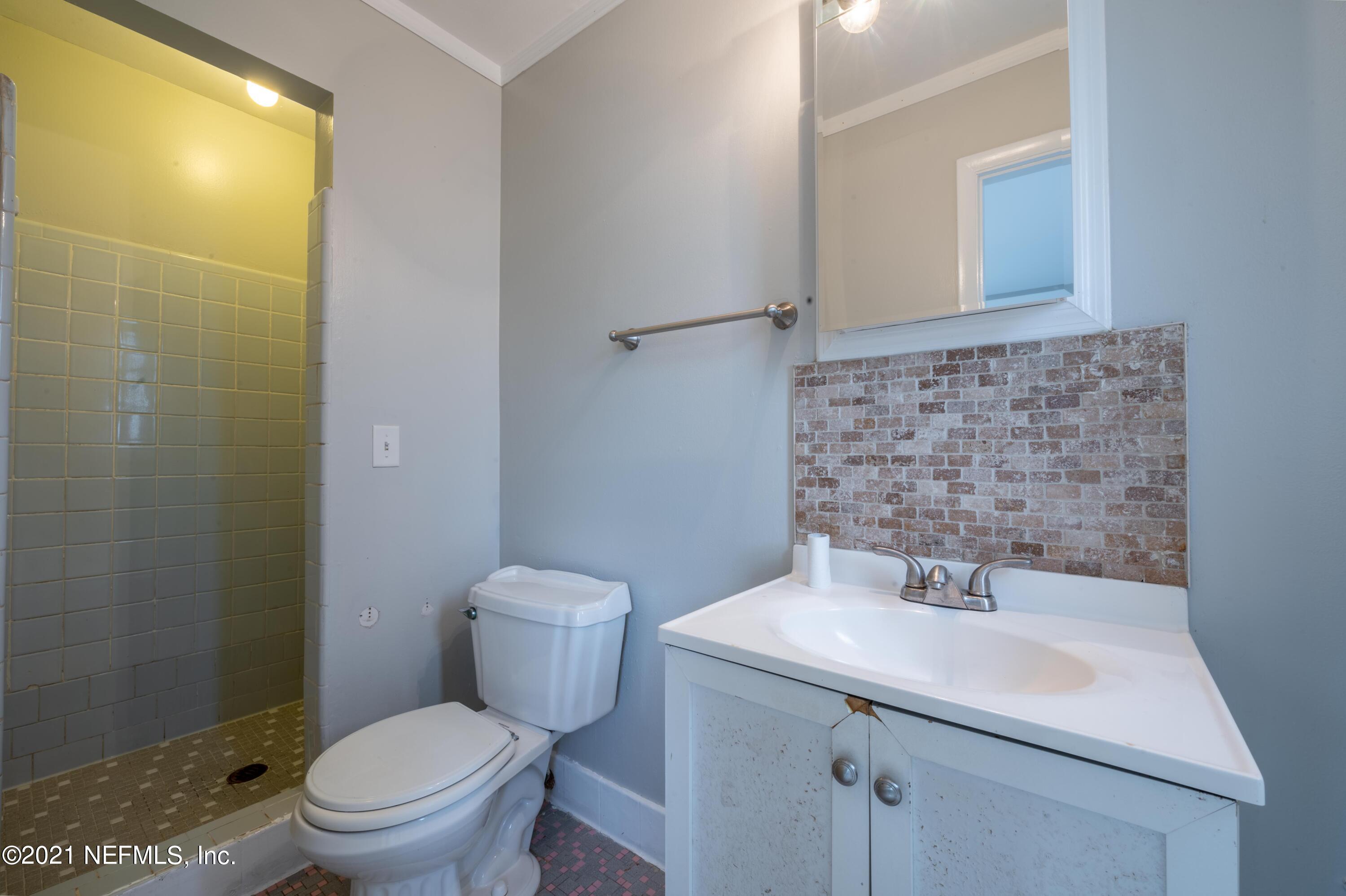 7521 Strato Road Jacksonville, FL 32210 - Photo 13 of 40 a bathroom with a sink toilet and a mirror