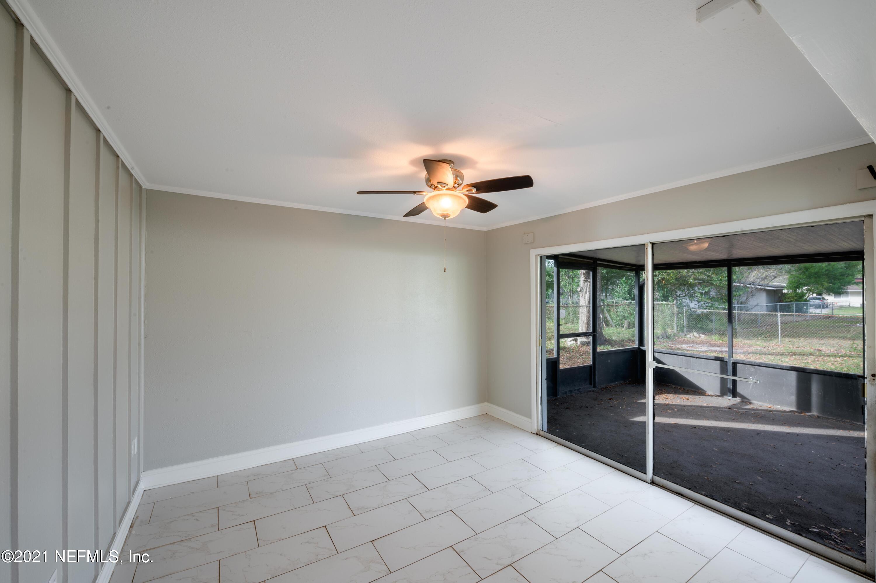 7521 Strato Road Jacksonville, FL 32210 - Photo 19 of 40 a view of a livingroom with a ceiling fan and window