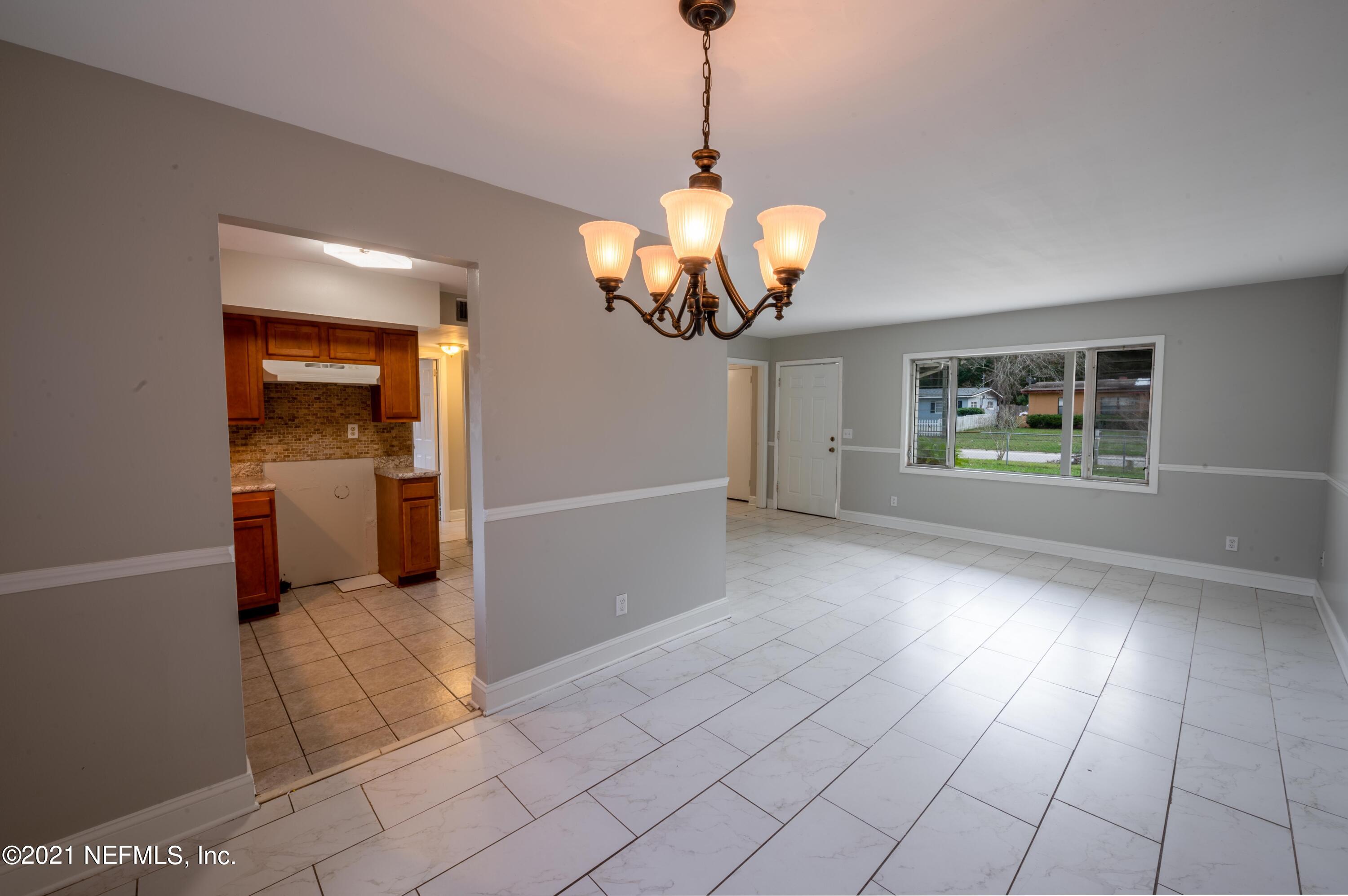 7521 Strato Road Jacksonville, FL 32210 - Photo 26 of 40 a view of a big room with windows and chandelier