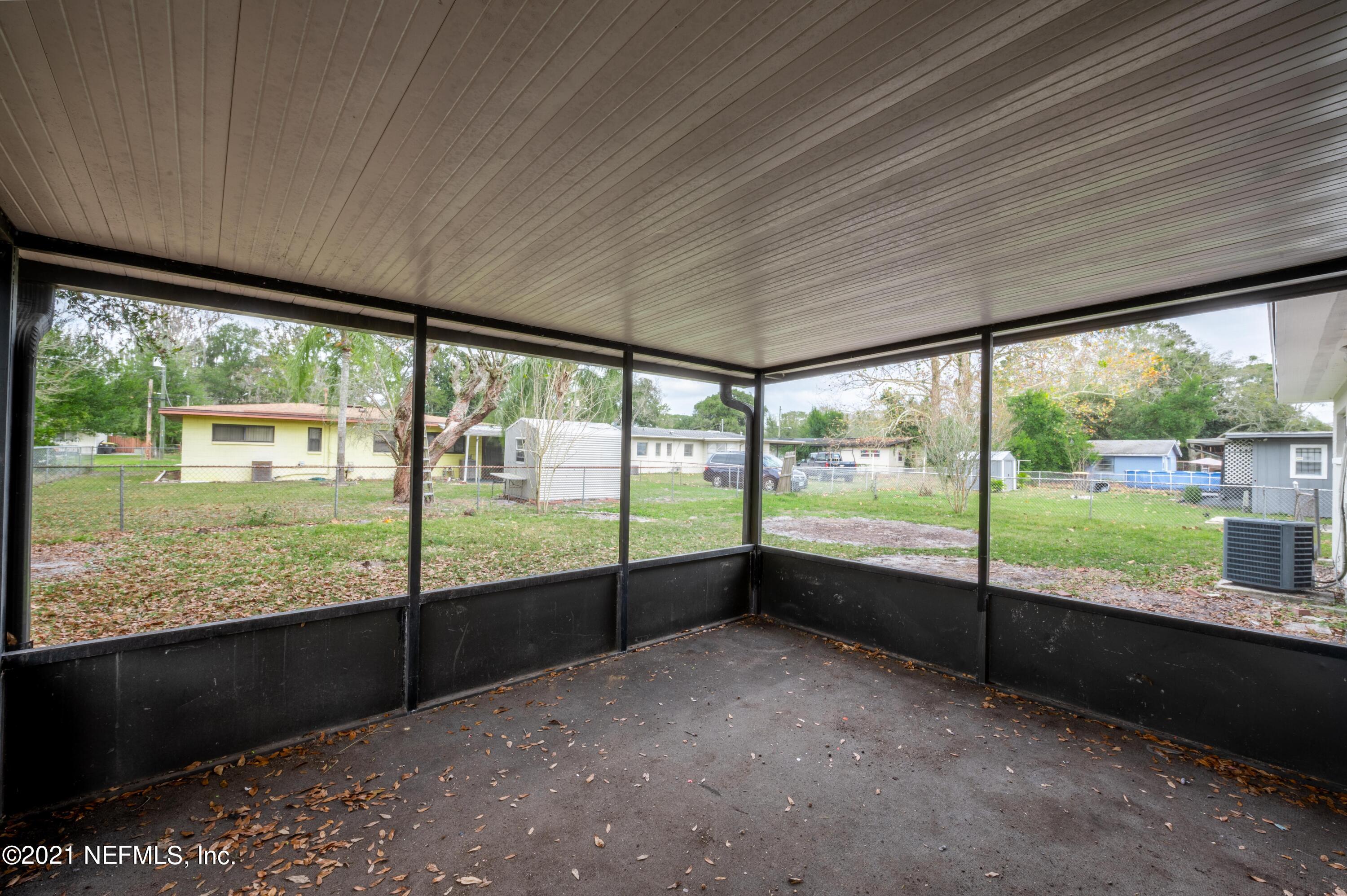 7521 Strato Road Jacksonville, FL 32210 - Photo 31 of 40 a view of an empty room with wooden floor and a floor to ceiling window