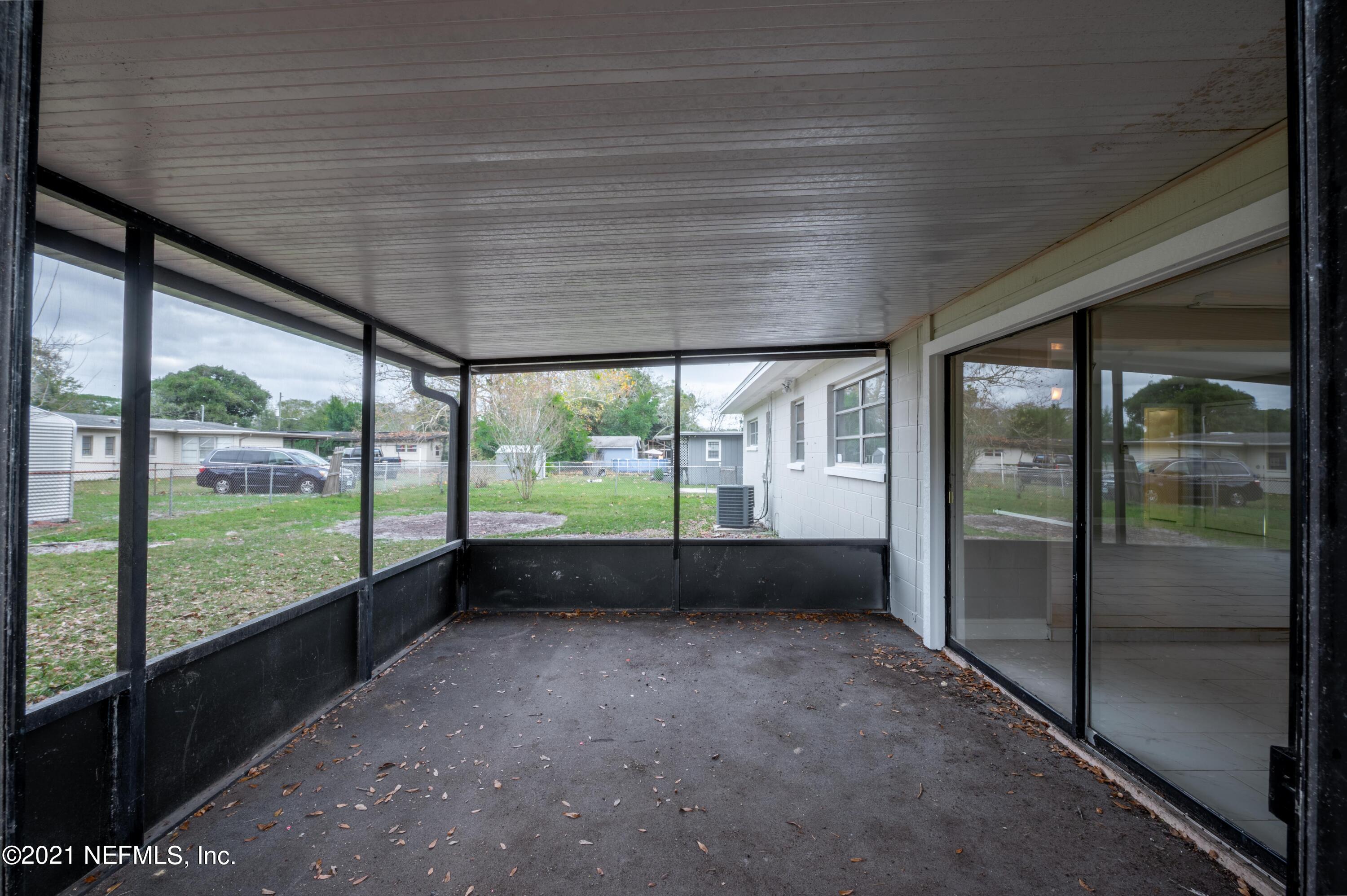 7521 Strato Road Jacksonville, FL 32210 - Photo 35 of 40 a view of an empty room with wooden floor and a balcony