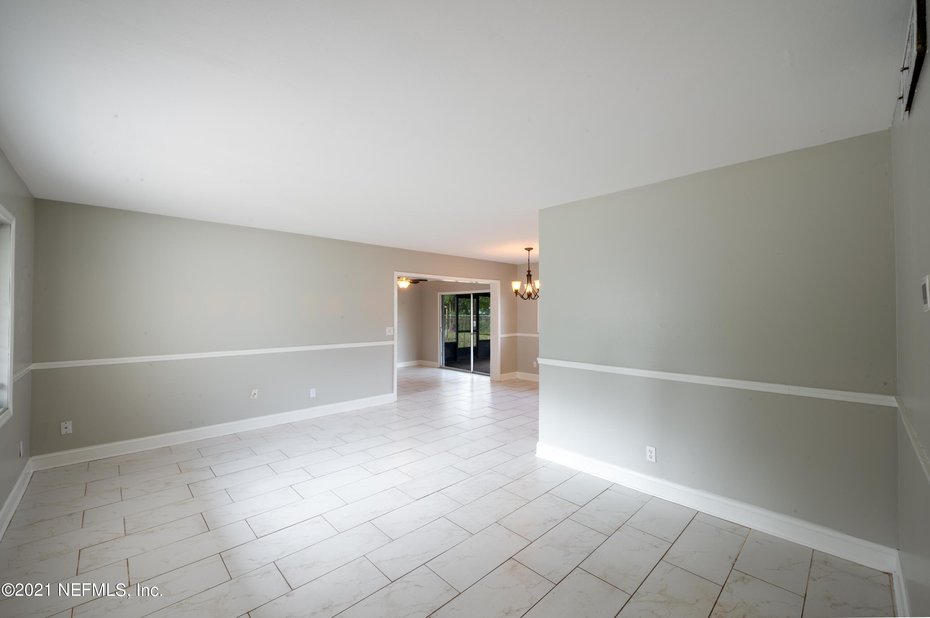7521 Strato Road Jacksonville, FL 32210 - Photo 38 of 40 an empty room with windows and white walls
