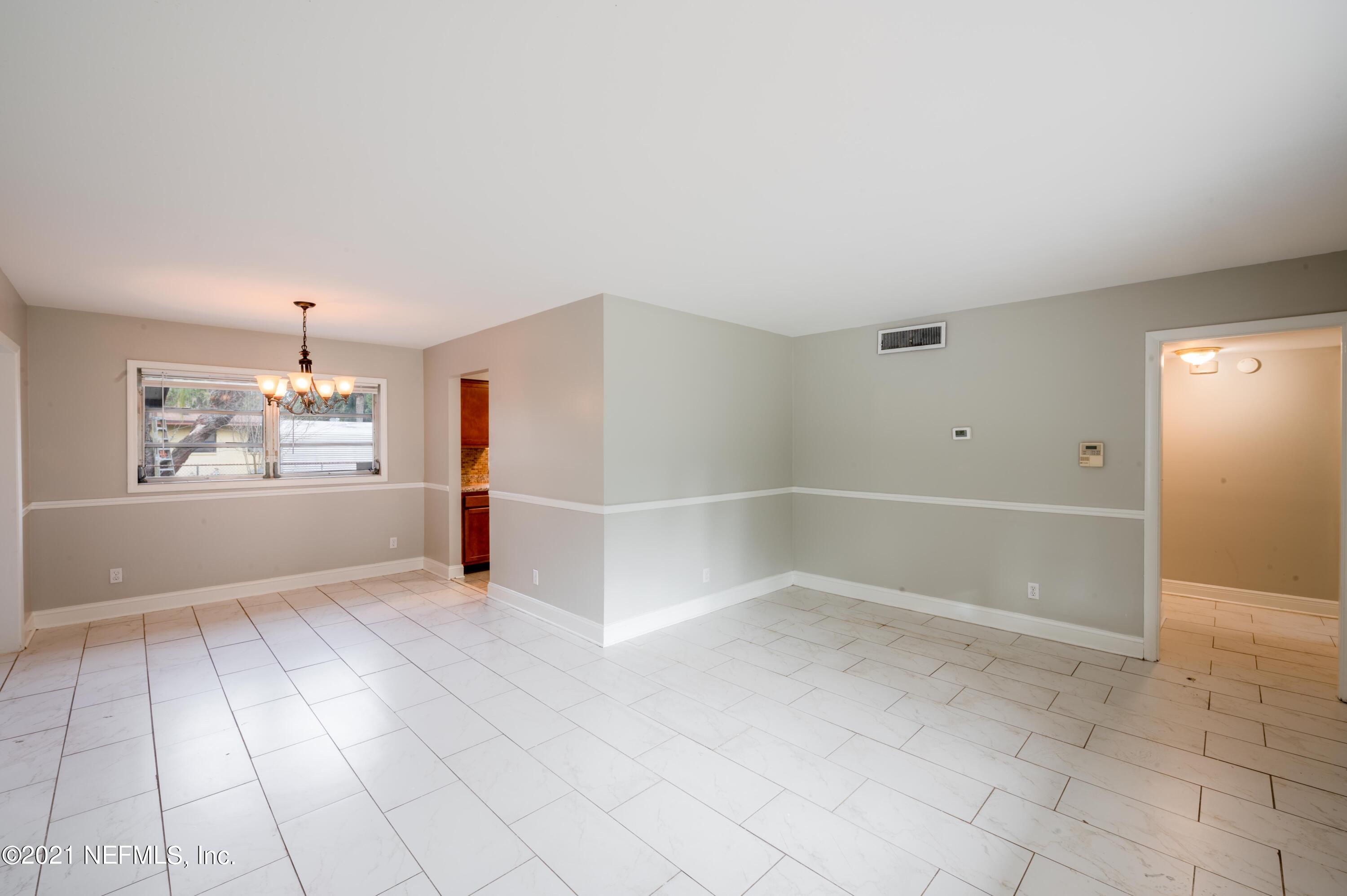 7521 Strato Road Jacksonville, FL 32210 - Photo 39 of 40 wooden floor in an empty room with a window