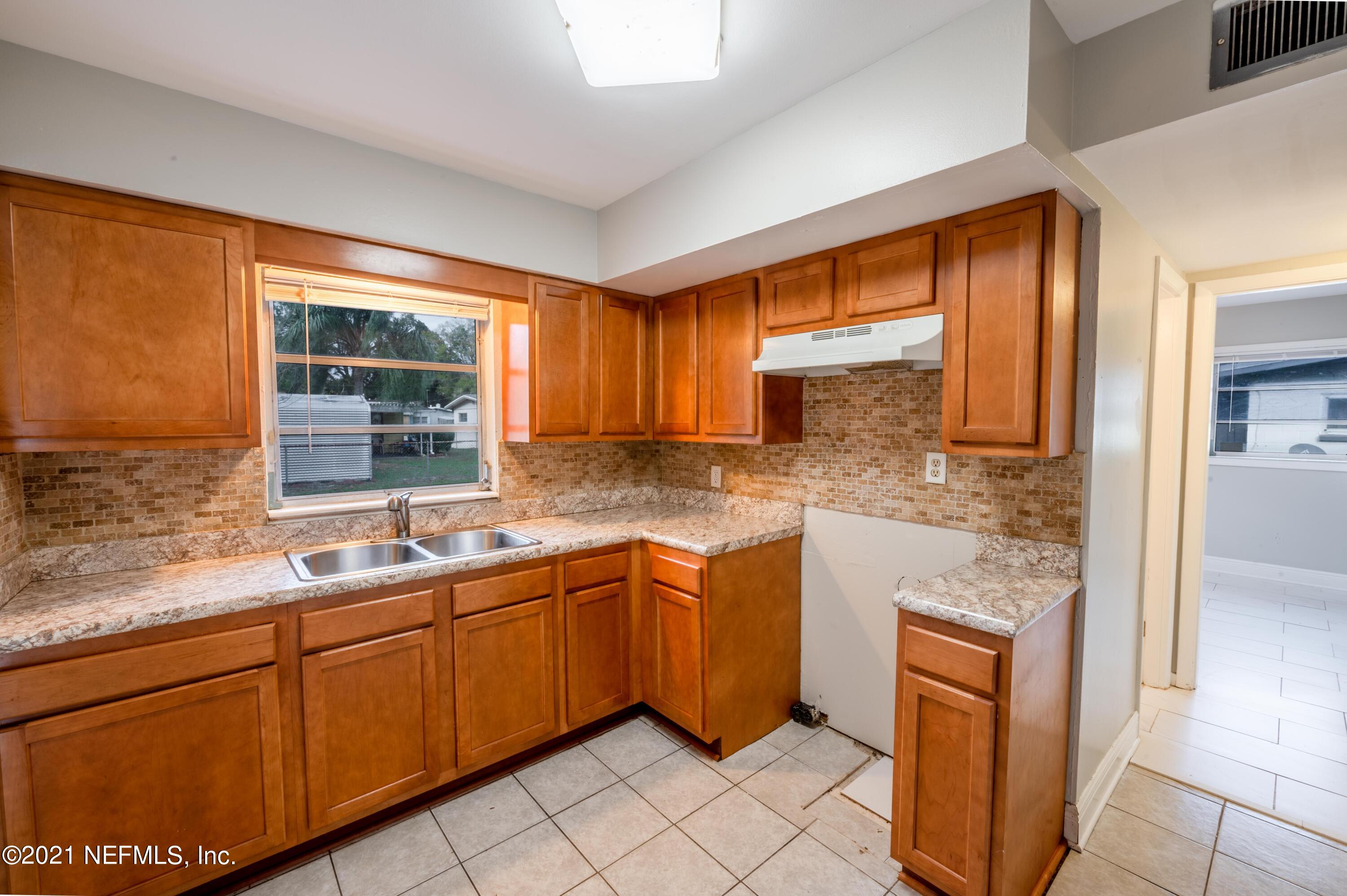 7521 Strato Road Jacksonville, FL 32210 - Photo 4 of 40 a kitchen with stainless steel appliances granite countertop sink stove and granite counter top