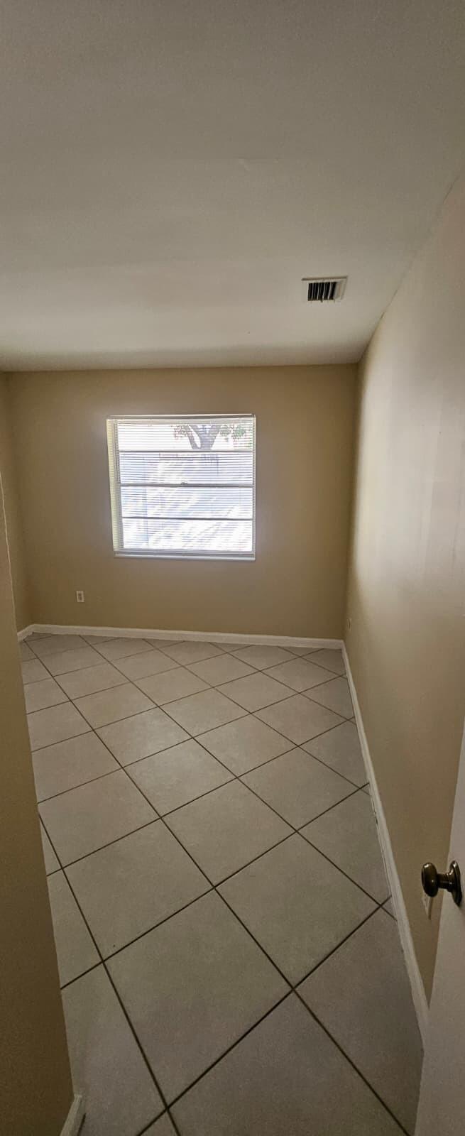 1202 Summer Street, Unit 3076 Palm Springs, FL 33461 - Photo 13 of 13 a view of an empty room and window
