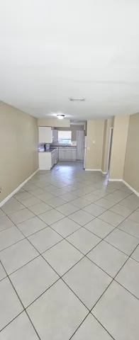 a view of kitchen and empty room