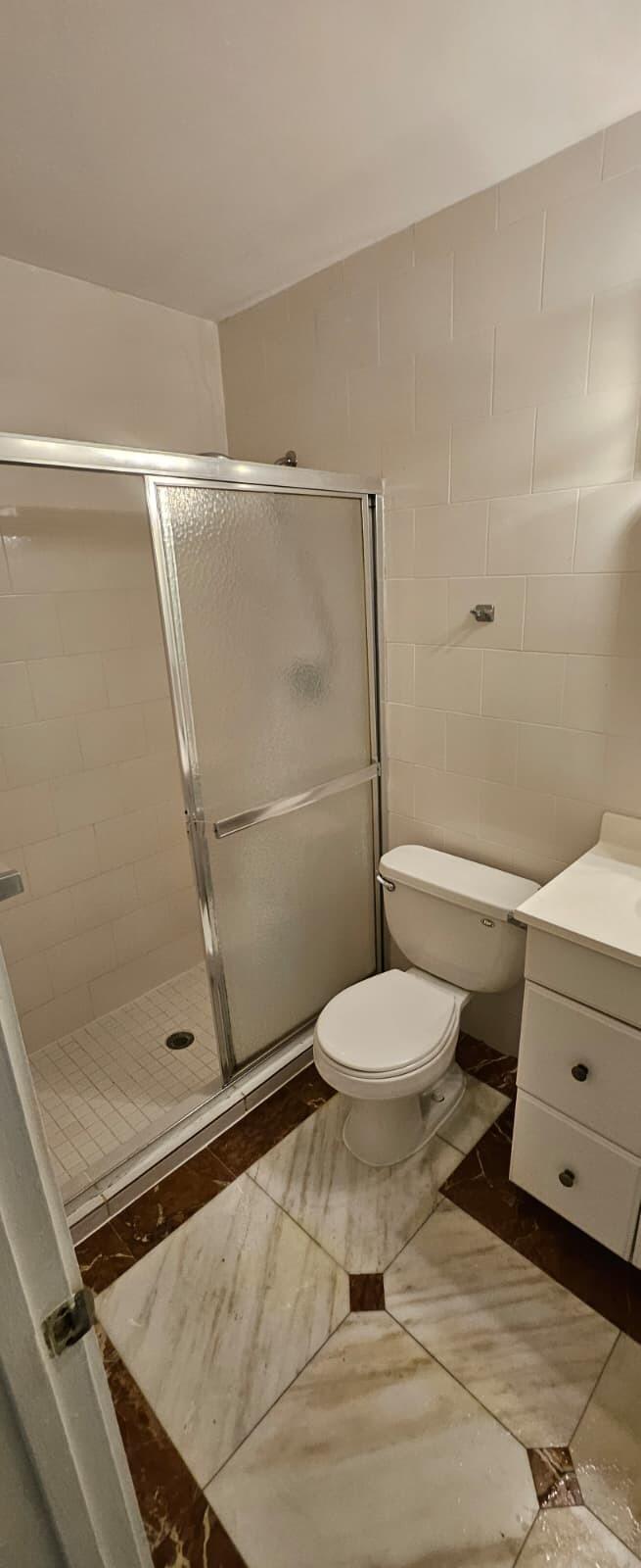 1202 Summer Street, Unit 3076 Palm Springs, FL 33461 - Photo 10 of 13 a bathroom with a toilet and a shower
