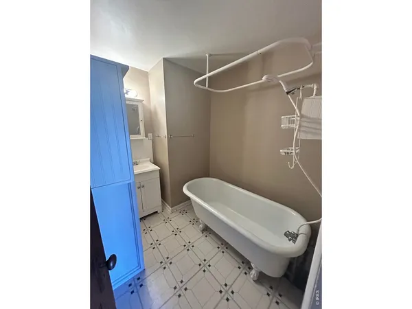 a toilet sitting in a bathroom next to a sink