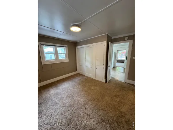 a view of an empty room with windows