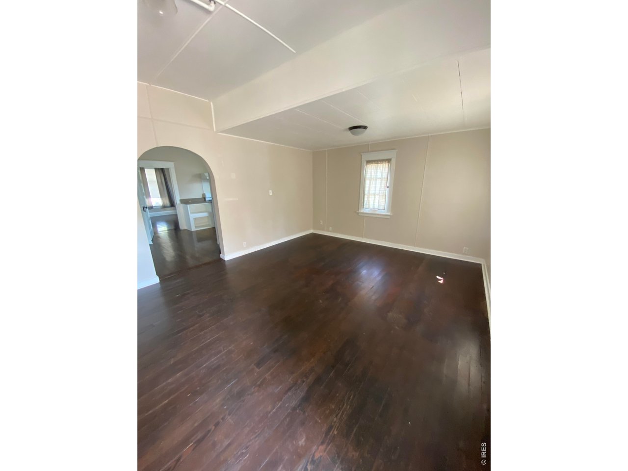 516 South Meldrum Street Fort Collins, CO 80521 - Photo 4 of 15 a view of an empty room with wooden floor and a window