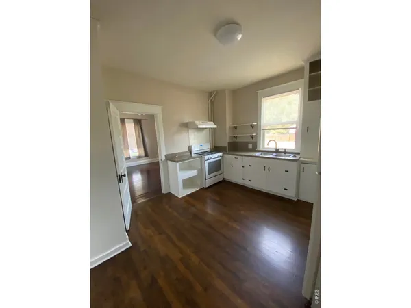 a kitchen with sink and cabinets
