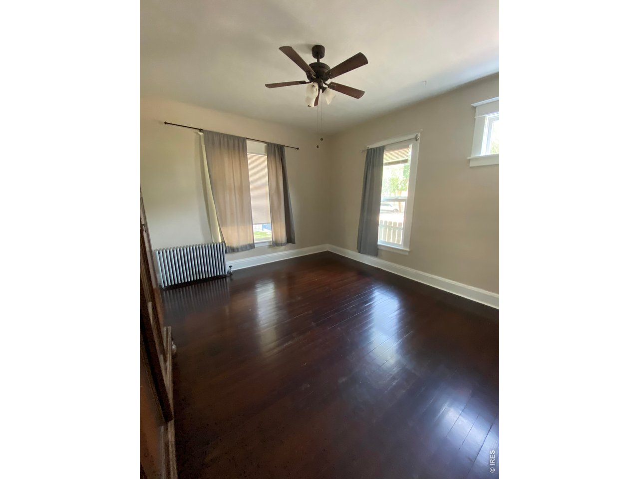 516 South Meldrum Street Fort Collins, CO 80521 - Photo 6 of 15 a view of a livingroom with wooden floor and a ceiling fan