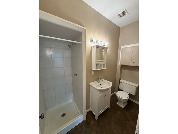a bathroom with a toilet a sink and shower