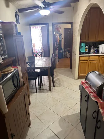 a living room with furniture a piano and a flat screen tv