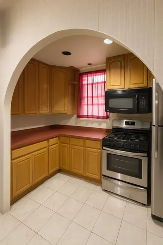 a kitchen with granite countertop a stove a sink and a microwave