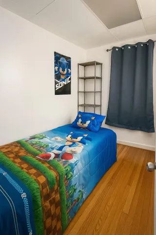 a bedroom with a bed and a window