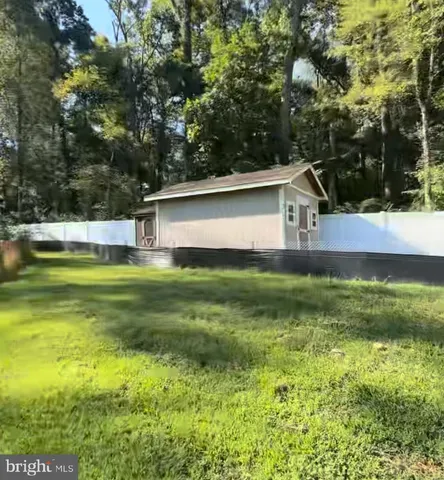 a front view of house with yard and trees